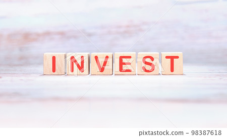 Invest text on wooden cubes, business concept Invest text on wooden cubes, business concept 98387618