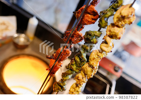 Lviv barbecue on the background of an Indian oven. Lviv barbecue on the background of an Indian oven. 98387822