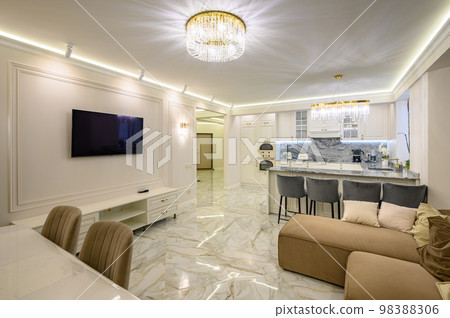 Studio apartment with classic kitchen featuring island used as dining area, and TV set 98388306