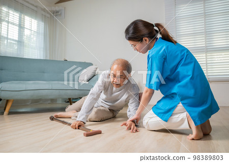 Asian older senior man falling down on lying floor and woman nurse came to help support, Disabled elderly old man patient fall down and caring young assistant at nursing home Asian older senior man falling down on lying floor and woman nurse came to help support, Disabled elderly old man patient fall down and caring young assistant at nursing home 98389803