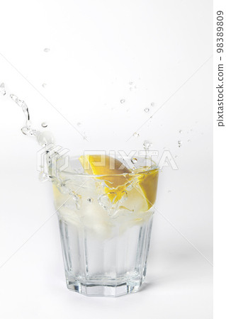 Glass of lemonade with splashing water on white background with copy space Glass of lemonade with splashing water on white background with copy space 98389809