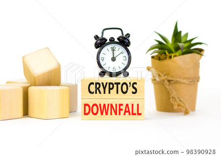 Crypto downfall symbol. Concept words Cryptos downfall on wooden blocks. Beautiful white table white background. Black alarm clock. House plant. Business and crypto downfall concept. Copy space. Crypto downfall symbol. Concept words Cryptos downfall on wooden blocks. Beautiful white table white background. Black alarm clock. House plant. Business and crypto downfall concept. Copy space. 98390928