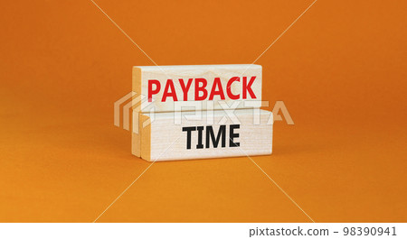 Payback time symbol. Concept words Payback time on wooden blocks. Beautiful orange table orange background. Business and payback time concept. Copy space. Payback time symbol. Concept words Payback time on wooden blocks. Beautiful orange table orange background. Business and payback time concept. Copy space. 98390941