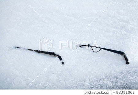 Car wipers and windscreen covered with snow Car wipers and windscreen covered with snow 98391062