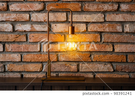 Bulb lamp against brick wall. Loft style design background. 98391241