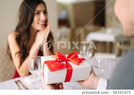 Valentine's Day concept. Happy couple in love. Couple celebrating Valentine's Day in restaurant. Valentine's Day concept. Happy couple in love. Couple celebrating Valentine's Day in restaurant. 98391975
