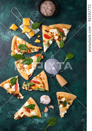Italian pizza with feta cheese, tomato and basil Italian pizza with feta cheese, tomato and basil 98392772