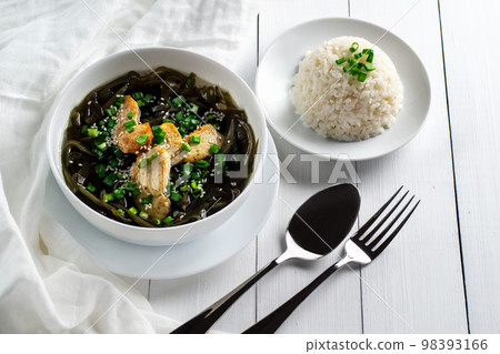 Korean cuisine. Healthy meals for pregnant women. Seaweed soup with meat in a white bowl. Birthday soup. Tradition. Custom. Top view. Korean cuisine. Healthy meals for pregnant women. Seaweed soup with meat in a white bowl. Birthday soup. Tradition. Custom. Top view. 98393166