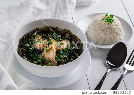 Korean seaweed soup with meat in white bowl and boiled rice. Birthday soup. Traditional Korean Cuisine. Healthy diet. Pregnancy. Custom. 98393167