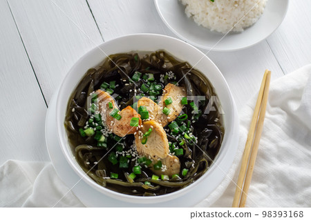 Korean cuisine. Healthy meals for pregnant women. Seaweed soup with meat in a white bowl. Birthday soup. Tradition. Custom. Top view. Korean cuisine. Healthy meals for pregnant women. Seaweed soup with meat in a white bowl. Birthday soup. Tradition. Custom. Top view. 98393168
