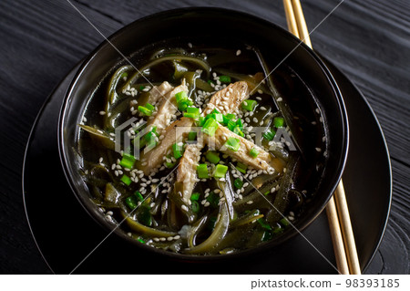 Korean seaweed soup with meat in black bowl. Birthday soup. Korean cuisine. Healthy nutrition. Pregnancy. View from above. Tradition. Custom. 98393185