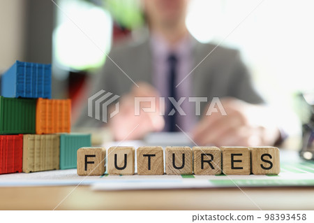 Word futures collected from cubes with cargo containers on office desk and business man in background. 98393458