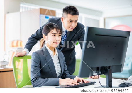 Business person having a meeting while looking at a computer 98394223