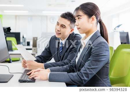 Business person having a meeting while looking at a computer 98394328