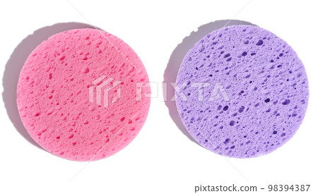Round purple and pink makeup sponges on a white isolated background Round purple and pink makeup sponges on a white isolated background 98394387
