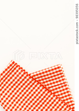 Orange cloth, a kitchen towel with a checkered pattern, on a whi Orange cloth, a kitchen towel with a checkered pattern, on a whi 98395056