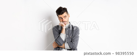 Gloomy thoughtful man looking aside, thinking or space out, staring at empty space bored, standing on white background 98395550