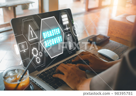 Disaster Recovery concept, Person hand using laptop computer with Disaster Recovery icon on virtual screen. Disaster Recovery concept, Person hand using laptop computer with Disaster Recovery icon on virtual screen. 98395781