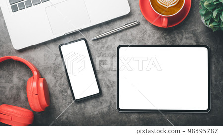 Office desk workplace with blank screen tablet and smartphone, laptop, pen, headphone and cup of coffee, Top view fkat kay. Office desk workplace with blank screen tablet and smartphone, laptop, pen, headphone and cup of coffee, Top view fkat kay. 98395787