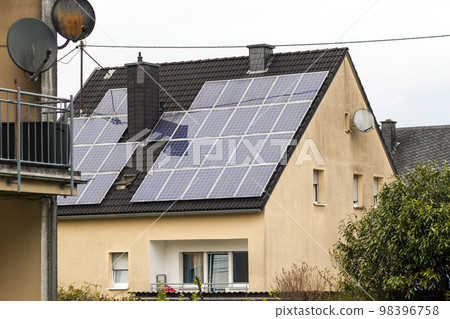 Renewable clean green energy saving efficient solar panels on suburban house roof. Renewable clean green energy saving efficient solar panels on suburban house roof. 98396758