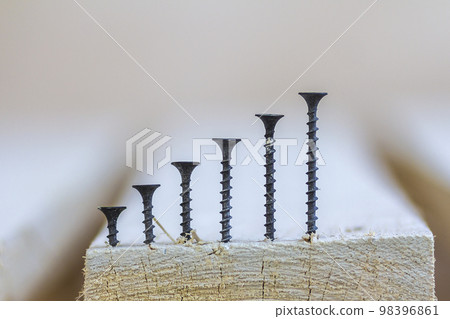 Positive graph made of screws as bar charts on board background Positive graph made of screws as bar charts on board background 98396861