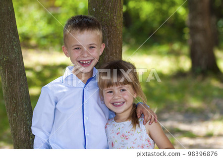 Portrait of a smiling hugging little girl and boy on a sunny day 98396876