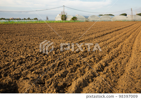 Plowed field with garden-beds in countryside 98397009
