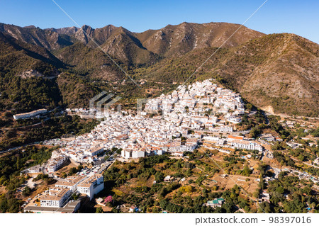 Drone view of the small town with white houses and surrounding countryside, Ojen, Spain in the summer Drone view of the small town with white houses and surrounding countryside, Ojen, Spain in the summer 98397016