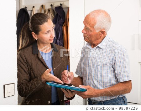 Elderly man signing financial agreement with bank worker Elderly man signing financial agreement with bank worker 98397229