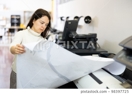 Woman working in publishing facility 98397725