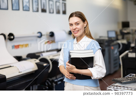Portrait of positive woman printing office worker Portrait of positive woman printing office worker 98397773