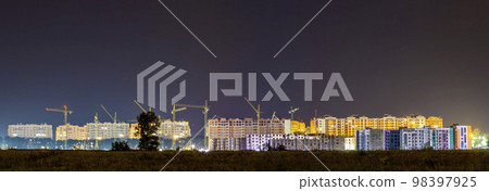 Panorama night view of many building cranes at construction site of new modern residential area Panorama night view of many building cranes at construction site of new modern residential area 98397925