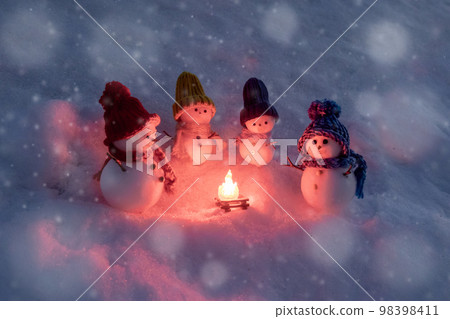 Snowmen surrounding a bonfire Snowmen surrounding a bonfire 98398411