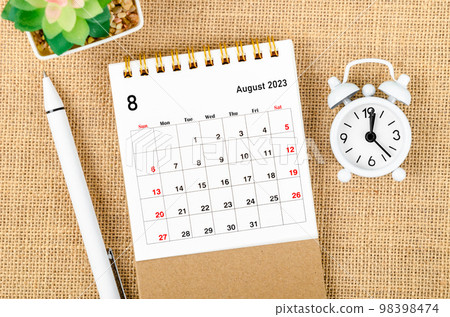The August 2023 Monthly desk calendar for the organizer to plan 2023 year with alarm clock and pen on sack background. 98398474