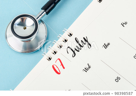 A July 2023 deskcalendar and medical stethoscope medical on blue background, schedule to check up healthy concepts. A July 2023 deskcalendar and medical stethoscope medical on blue background, schedule to check up healthy concepts. 98398587