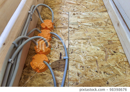 New electrical installation, socket plastic boxes and electrical cables on the wall, renovation concept. Electrical wiring installation. New electrical installation, socket plastic boxes and electrical cables on the wall, renovation concept. Electrical wiring installation. 98398676