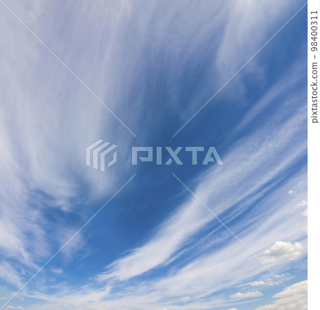 Dramatic blue sky with puffy white clouds in bright clear sunny day 98400311