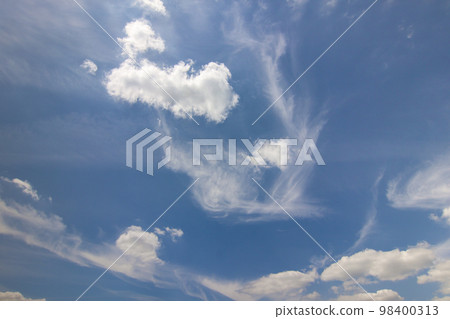 Dramatic blue sky with puffy white clouds in bright clear sunny day Dramatic blue sky with puffy white clouds in bright clear sunny day 98400313