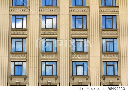 Details of windows of new constructed colorful multi-story building. Modern residential construction. Residential fund. Building of the city. New yellow house 98400330