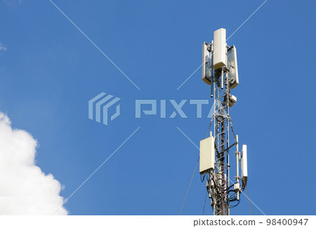Communication antenna tower with blue sky,Telecoms technology. Mobile phone base station 98400947