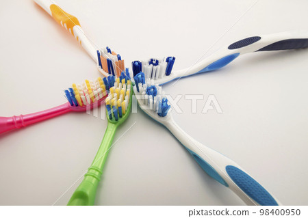 Colorful toothbrushes on white background with copy space. Macro Colorful toothbrushes on white background with copy space. Macro 98400950
