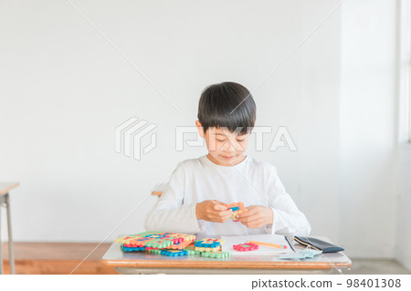 A boy in the lower grades of elementary school who learns English and English words with alphabet toys (intellectual education) A boy in the lower grades of elementary school who learns English and English words with alphabet toys (intellectual education) 98401308