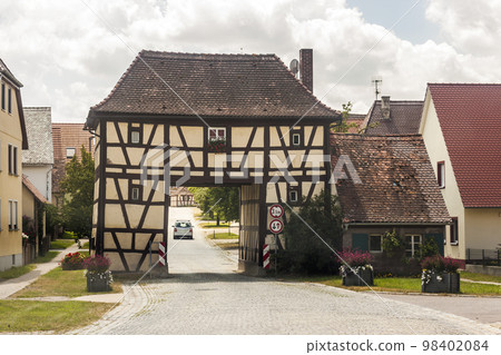 Building over the road in rural Germany village. Old house as example of old german architecture 98402084