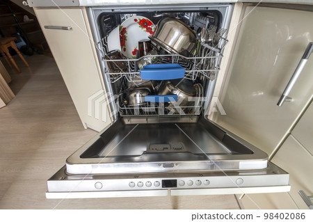 Build-in dishwasher with opened door with clean glass and dishes in modern kitchen, selective focus Build-in dishwasher with opened door with clean glass and dishes in modern kitchen, selective focus 98402086