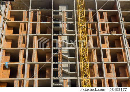 Multi storied apartment building is being constructed along in progress works on construction site Multi storied apartment building is being constructed along in progress works on construction site 98403177
