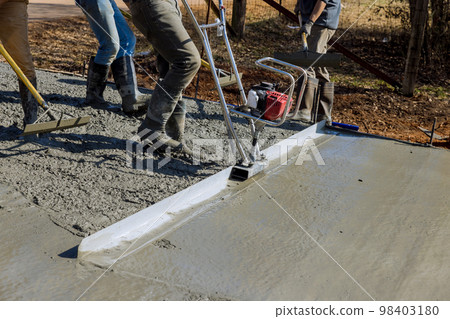 Machine is used in construction of new driveway to align new concrete layer on top compacted layer 98403180