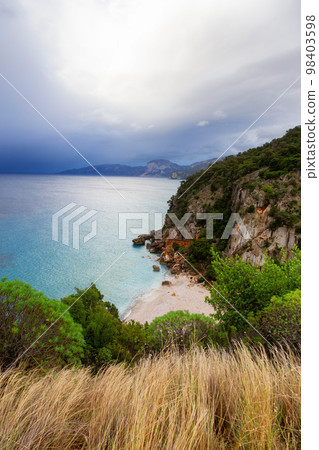 Sandy Beach on a rocky coast near Cala Gonone, Sardinia. Sandy Beach on a rocky coast near Cala Gonone, Sardinia. 98403598