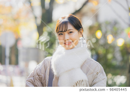 Winter woman walking outdoors Winter woman walking outdoors 98405445