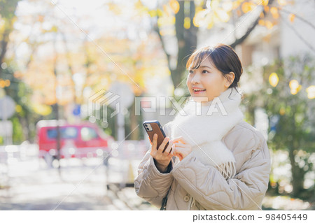Winter woman walking outdoors 98405449