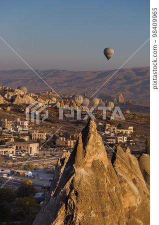 Cappadocia. View of Goreme town with caves and hot air balloons in Cappadocia. Turkey. 98409965
